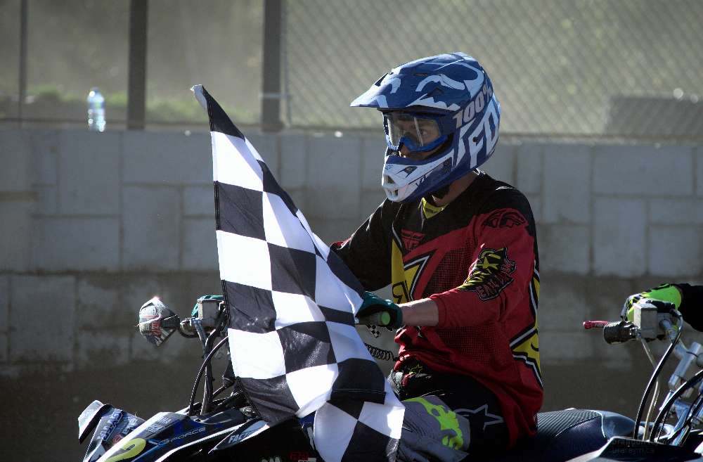 atv racer holding a flag